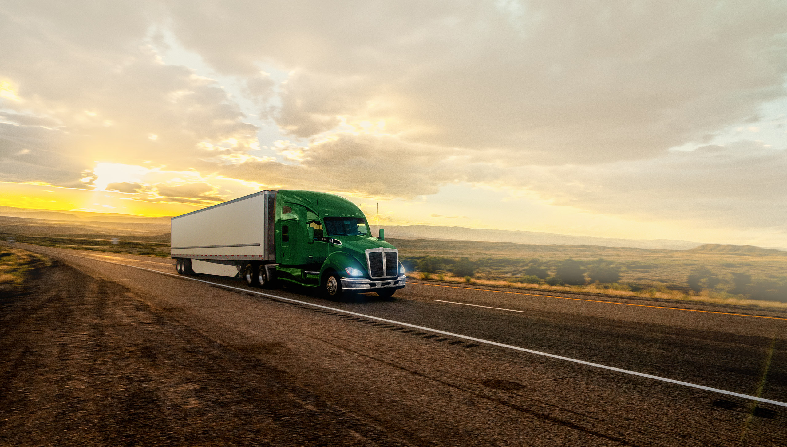 A transport truck and trailer driving on the highway transporting freight